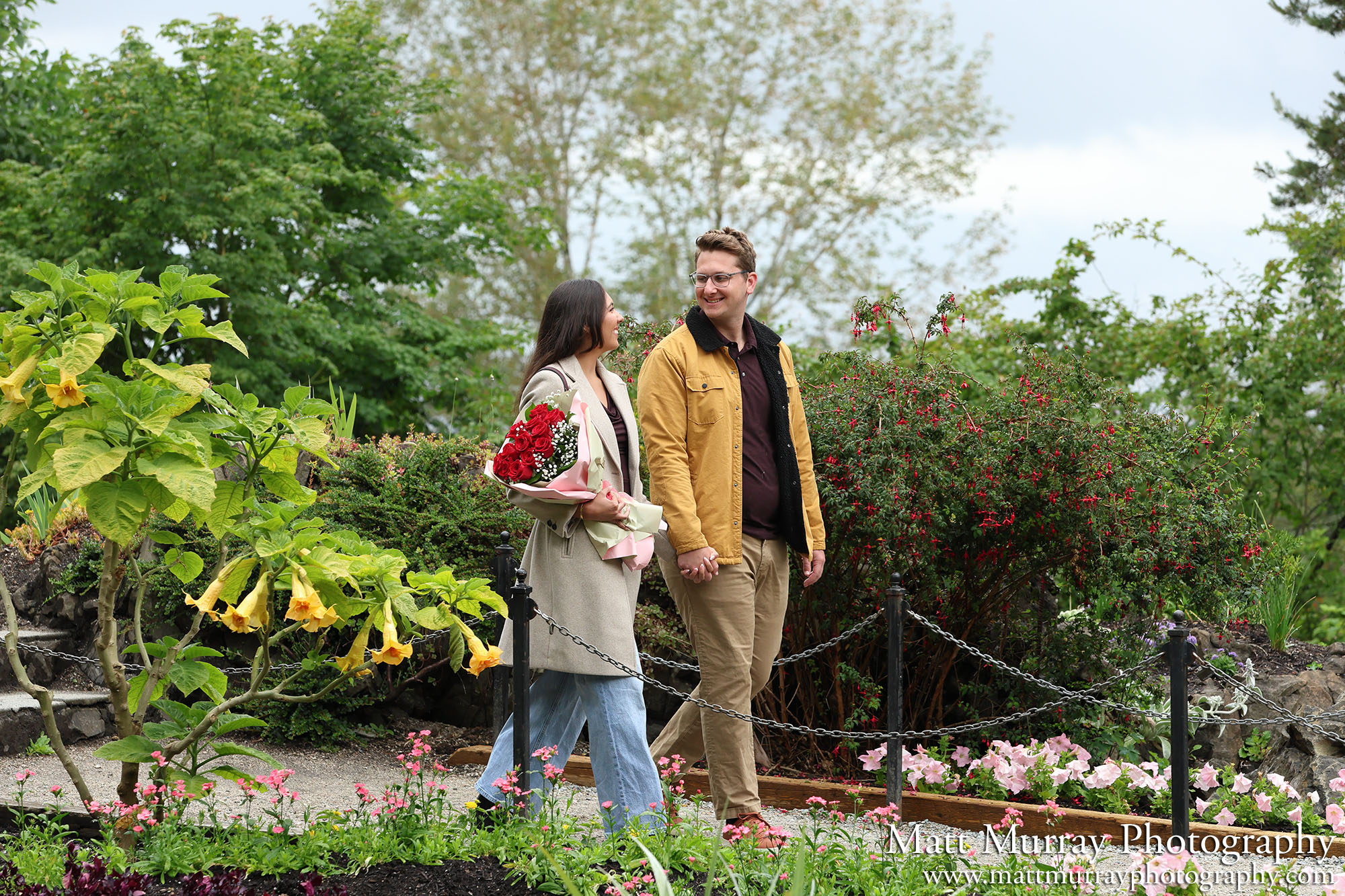 A couple walking on the path at the Small Quarry Gardens in Vancouver, BC.