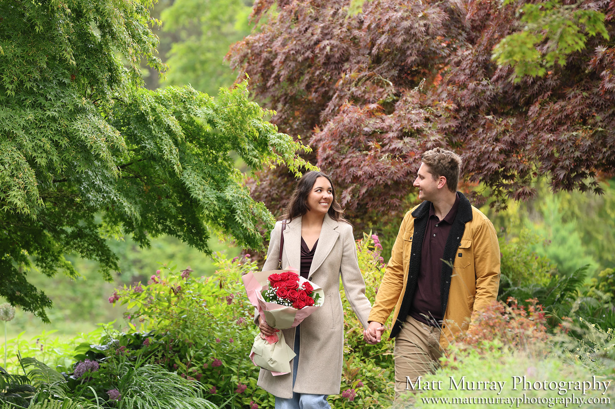 A couple walking at the park during the summer season.